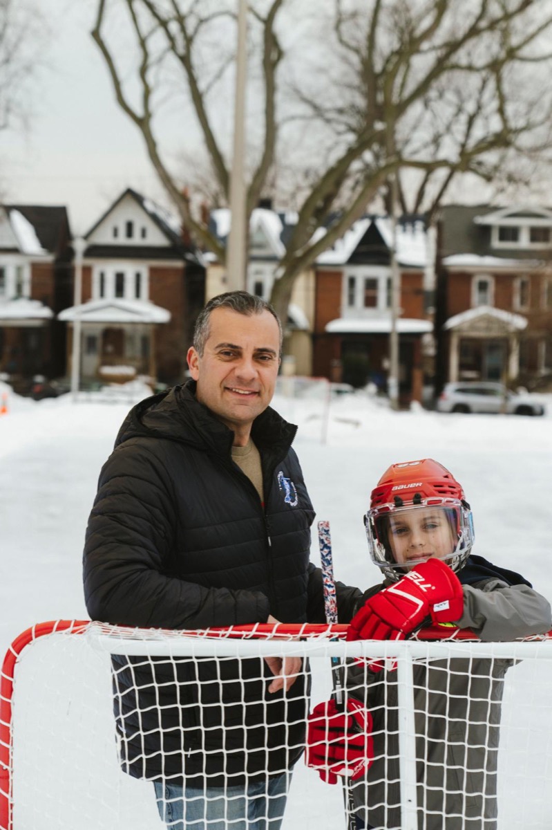 Marco Martins with a young hockey player at the community ice rink in Ward 9 Davenport